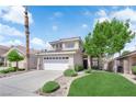 Charming two-story home with a well-manicured lawn and a two-car garage at 21 Rue De Degas, Henderson, NV 89074