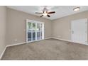Neutral living room with a ceiling fan and sliding door to the outside at 2291 W Horizon Ridge Pkwy # 6131, Henderson, NV 89052