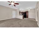 View of living room, showcasing neutral walls, carpeted floor, and a ceiling fan at 2291 W Horizon Ridge Pkwy # 6131, Henderson, NV 89052