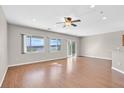 Bright living room featuring wood floors, a ceiling fan, and plenty of natural light at 2428 Hamonah Dr, Henderson, NV 89044