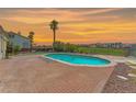 Beautiful in-ground pool with brick decking and unobstructed views of the golf course and sunset at 2997 Via Meridiana, Henderson, NV 89052