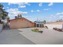 Large backyard features a fire pit, covered area, patio, and a chain-link fence at 3715 Tabor Ave, North Las Vegas, NV 89030