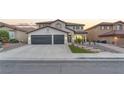 Beautiful two-story home with a two-car garage and xeriscaped front yard at 387 Hoskins Ct, Henderson, NV 89012