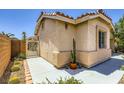 Close-up of the side of the home highlighting the stucco exterior, tiled roof, and desert landscaping at 4361 Valley Quail Way, North Las Vegas, NV 89084