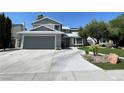 Charming two-story home features a gray facade, well-maintained landscaping, and a spacious two-car garage at 4385 Newhaven Dr, Las Vegas, NV 89147