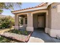 Charming front porch featuring decorative brickwork, a small garden, and a welcoming entrance at 4825 White Aspen Ave, Las Vegas, NV 89130