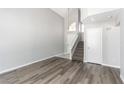 Bright foyer area showcasing hardwood floors, a staircase, and neutral paint for a welcoming ambiance at 6112 Grape Blossom Ave, Las Vegas, NV 89142