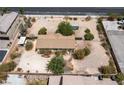 Aerial view of home sitting on a sand lot with desert landscaping and block wall fence at 6337 W Cactus Ave, Las Vegas, NV 89141