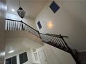 Beautiful staircase with black railings and white walls, leading to the upper level of the home at 6412 Point Break St, North Las Vegas, NV 89084