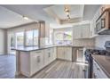 Modern kitchen featuring stainless steel appliances, gray countertops, and ample cabinet space at 6848 Groveview Ln, Las Vegas, NV 89103