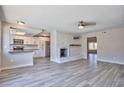 Open-concept living area with a charming brick fireplace and seamless flow into the modern kitchen at 6848 Groveview Ln, Las Vegas, NV 89103
