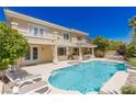 A stunning outdoor pool featuring an integrated spa, built-in bar, and lounge chairs at 712 Proud Eagle Ln, Las Vegas, NV 89144