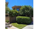 Well-maintained stucco home with manicured landscaping and privacy hedges around the property at 7201 Mission Hills Dr, Las Vegas, NV 89113