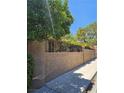 Long stucco fence topped with decorative ironwork and providing security and privacy to the property at 7201 Mission Hills Dr, Las Vegas, NV 89113