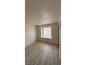 Bedroom with wood-look floors and a window at 7300 Pirates Cove Rd # 2031, Las Vegas, NV 89145