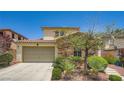 Two-story home with a terracotta roof, a two-car garage, and desert landscaping at 776 Tillis Pl, Las Vegas, NV 89138