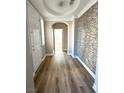 Inviting hallway boasts stylish tiled accent wall and hardwood floors at 776 Tillis Pl, Las Vegas, NV 89138