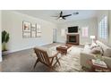 Bright living room with a ceiling fan, fireplace, and comfortable seating arrangement at 776 Tillis Pl, Las Vegas, NV 89138
