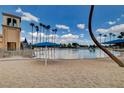 Beautiful community pool with sandy beach area and shade canopies in desert landscape at 8416 Dry Cliff Cir, Las Vegas, NV 89128