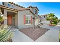 Charming two-story house with well-kept landscaping, featuring a walkway and a covered porch at 9021 Rendon St, Las Vegas, NV 89143