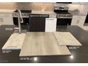 Kitchen with stainless steel appliances, modern cabinets, quartz countertop, and luxury vinyl plank flooring at 9125 Rivington Ave, Las Vegas, NV 89148