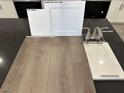 Close-up of kitchen selection showcasing cabinet, counter, and vinyl flooring samples at 9534 Marsh Aster St, Las Vegas, NV 89139