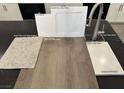 Close-up showcasing carpet, counter, cabinet, and vinyl flooring samples for kitchen customization at 9534 Marsh Aster St, Las Vegas, NV 89139