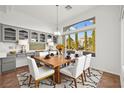 Elegant dining room with gray cabinetry and a large window offering scenic outdoor views at 10920 Grand Haven Ave, Las Vegas, NV 89134