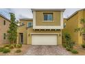 Attractive two-story house with a well-maintained lawn, a two-car garage, and paved driveway at 113 Manzanita Falls Ave, North Las Vegas, NV 89031