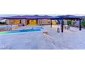 Inviting backyard featuring a pool, spa, and covered patio, perfect for outdoor relaxation at 12168 Dorada Coast Ave, Las Vegas, NV 89138