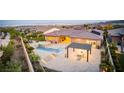 Aerial view of a backyard with a pool, spa, covered patio, and lush landscaping at 12168 Dorada Coast Ave, Las Vegas, NV 89138