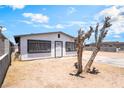 Charming home featuring security bars, a white door, and minimal landscaping at 1328 Balzar Ave, Las Vegas, NV 89106