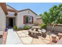 Charming courtyard featuring a quaint stone table with benches, accessible from the front entrance of the house at 2555 Moonlight Valley Ave, Henderson, NV 89044