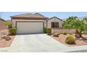 Inviting single-story home showcasing a well-maintained front yard and an attached two-car garage at 2555 Moonlight Valley Ave, Henderson, NV 89044