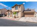 Low angle exterior view of a two-story home featuring neutral stucco and a small palm tree in the front yard at 2745 Poppyseed Way, Las Vegas, NV 89142