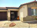 View of the front entrance and garage showcasing the home's inviting curb appeal at 2822 Chetco River St, Laughlin, NV 89029