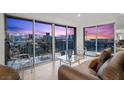 Living room with sliding glass doors opening to a balcony and showcasing a vibrant city view at 3111 Bel Air Dr # 21A & 21C, Las Vegas, NV 89109