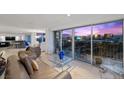 Spacious living room featuring a balcony with stunning sunset views of the city skyline at 3111 Bel Air Dr # 21A & 21C, Las Vegas, NV 89109