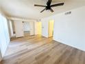 Bedroom features wood-look flooring, mirrored closet doors, and direct access to a bathroom at 3270 Liahona Way, Las Vegas, NV 89121
