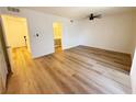 Bedroom with wood-look floors, a ceiling fan, access to a bathroom and well lit hall at 3270 Liahona Way, Las Vegas, NV 89121