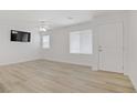 Bright living room with wood-look floors and a modern ceiling fan at 3621 Arcadian Sea St, Las Vegas, NV 89106