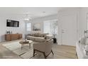 Bright living room featuring modern furniture, neutral tones, and a cozy atmosphere, virtually staged at 3621 Arcadian Sea St, Las Vegas, NV 89106