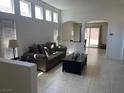 Bright living room featuring tile floors, high ceilings, and arched doorways to other rooms at 3712 Garnet Heights Ave, North Las Vegas, NV 89081