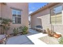 Charming courtyard area with a bench, table, and desert landscaping at 4408 Oasis Plains Ave, North Las Vegas, NV 89085