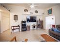 Spacious living room featuring a ceiling fan, tile flooring, and comfortable seating at 4616 E Idaho Ave, Las Vegas, NV 89104