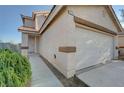 Close up of home's exterior with a two-car garage and drought-resistant landscaping at 4751 Lone Grove Dr, Las Vegas, NV 89139