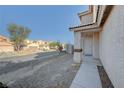 Shot of house's front entry showing drought-resistant landscaping and sidewalk at 4751 Lone Grove Dr, Las Vegas, NV 89139