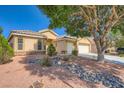 Charming single-story home featuring a well-maintained yard, two-car garage and desert landscaping at 5817 Pirate Ship Dr, North Las Vegas, NV 89031