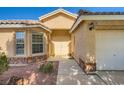 Inviting single-story home with a stone-accented facade, well-manicured landscaping and a two-car garage at 5817 Pirate Ship Dr, North Las Vegas, NV 89031