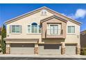 Charming townhome features multiple car garages, balcony, and a stucco exterior with a tile roof at 8798 Tom Noon Ave # 103, Las Vegas, NV 89178
